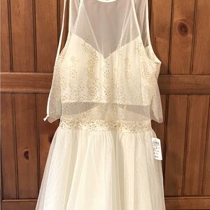 Festive dress with gold embroidered toile overlay.Just above the knee.